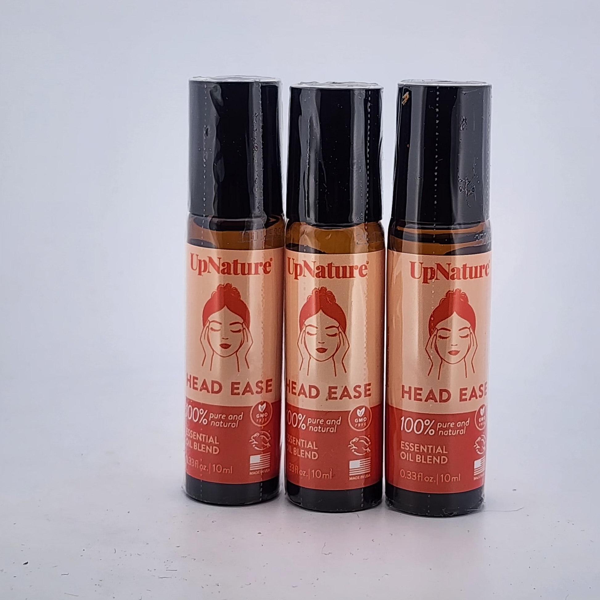Three bottles of UpNature Head Ease on a white background