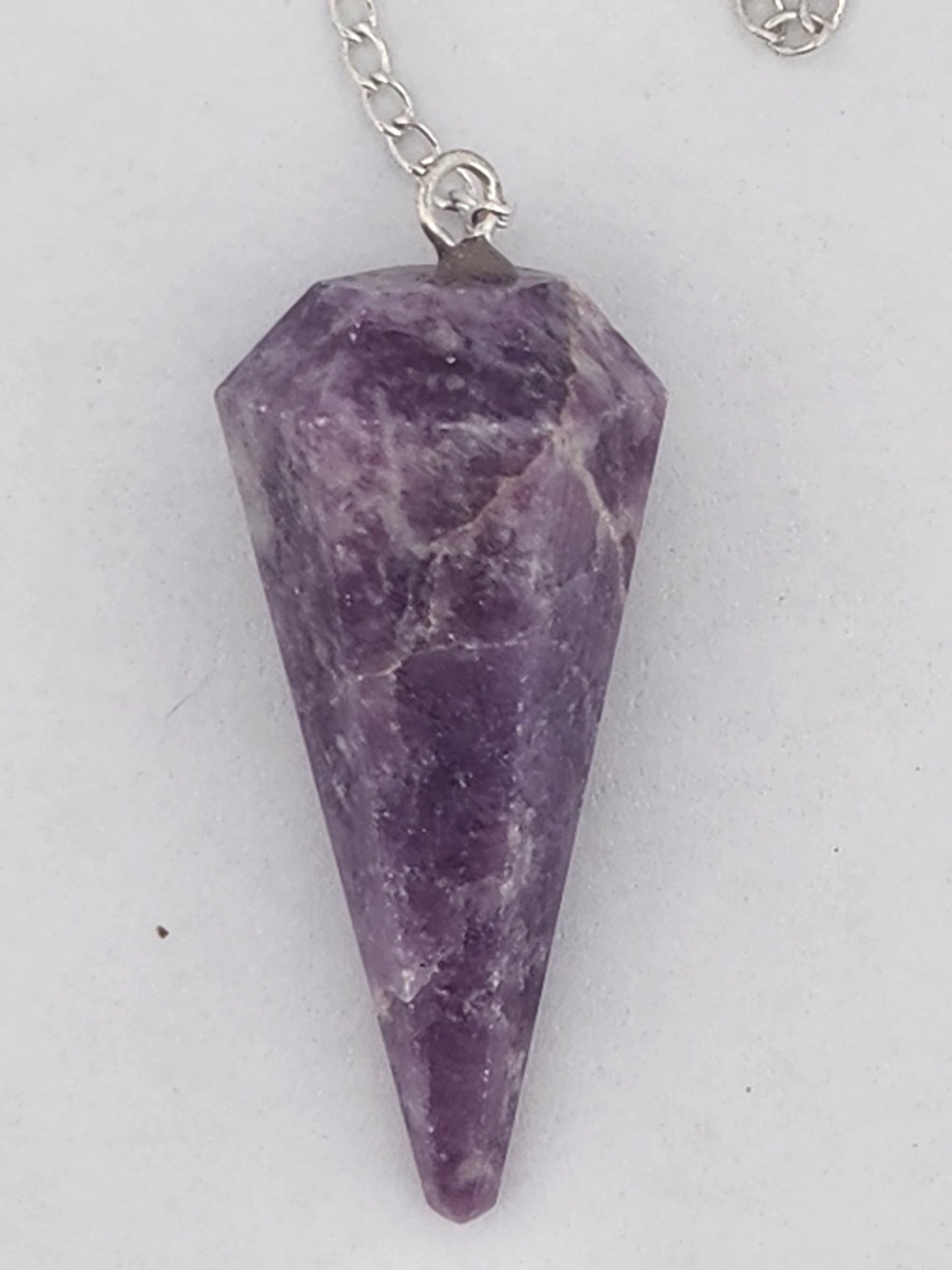 Purple stone pendant on a white background