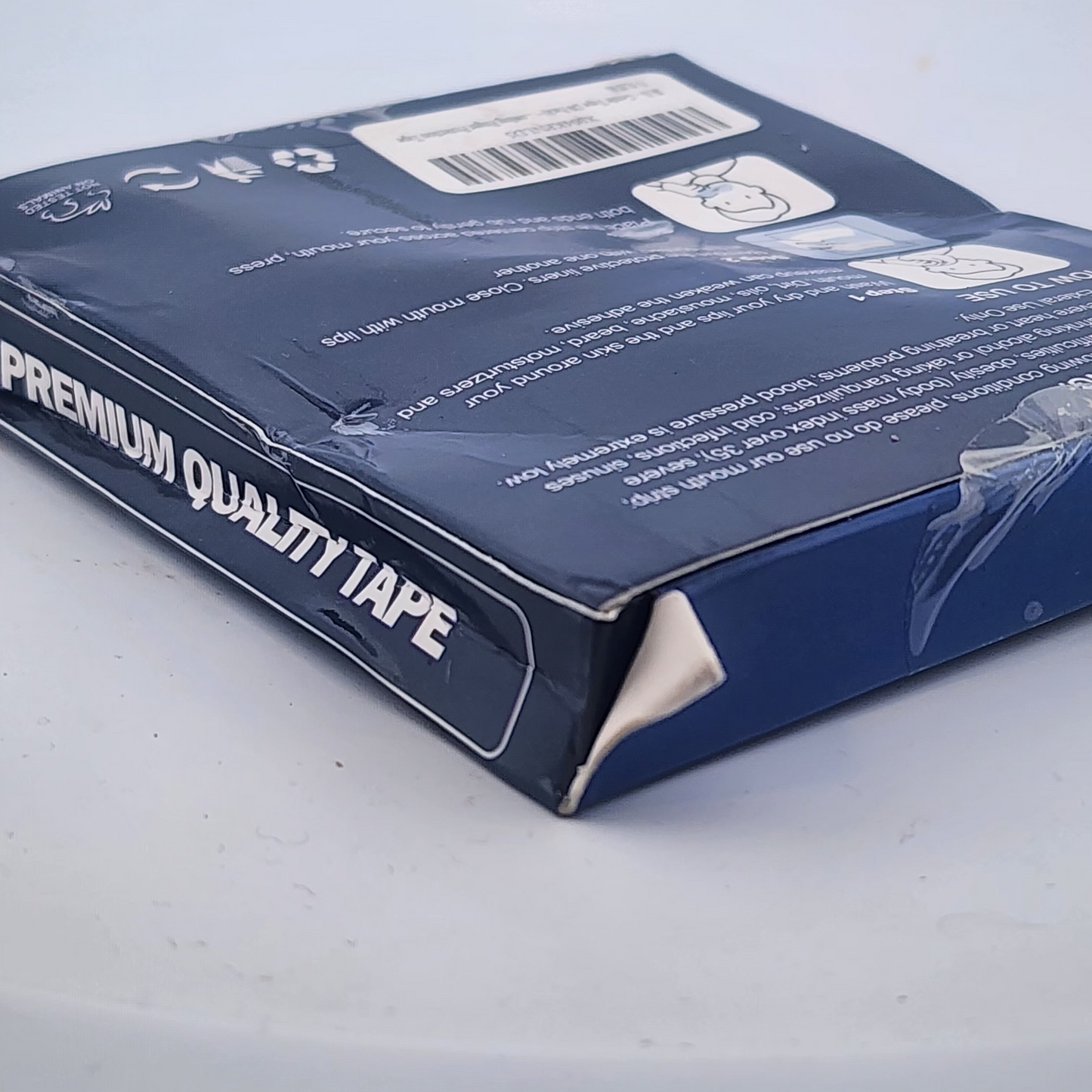 Blue tape dispenser packaging with 'Premium Quality Tape' text on a light gray background