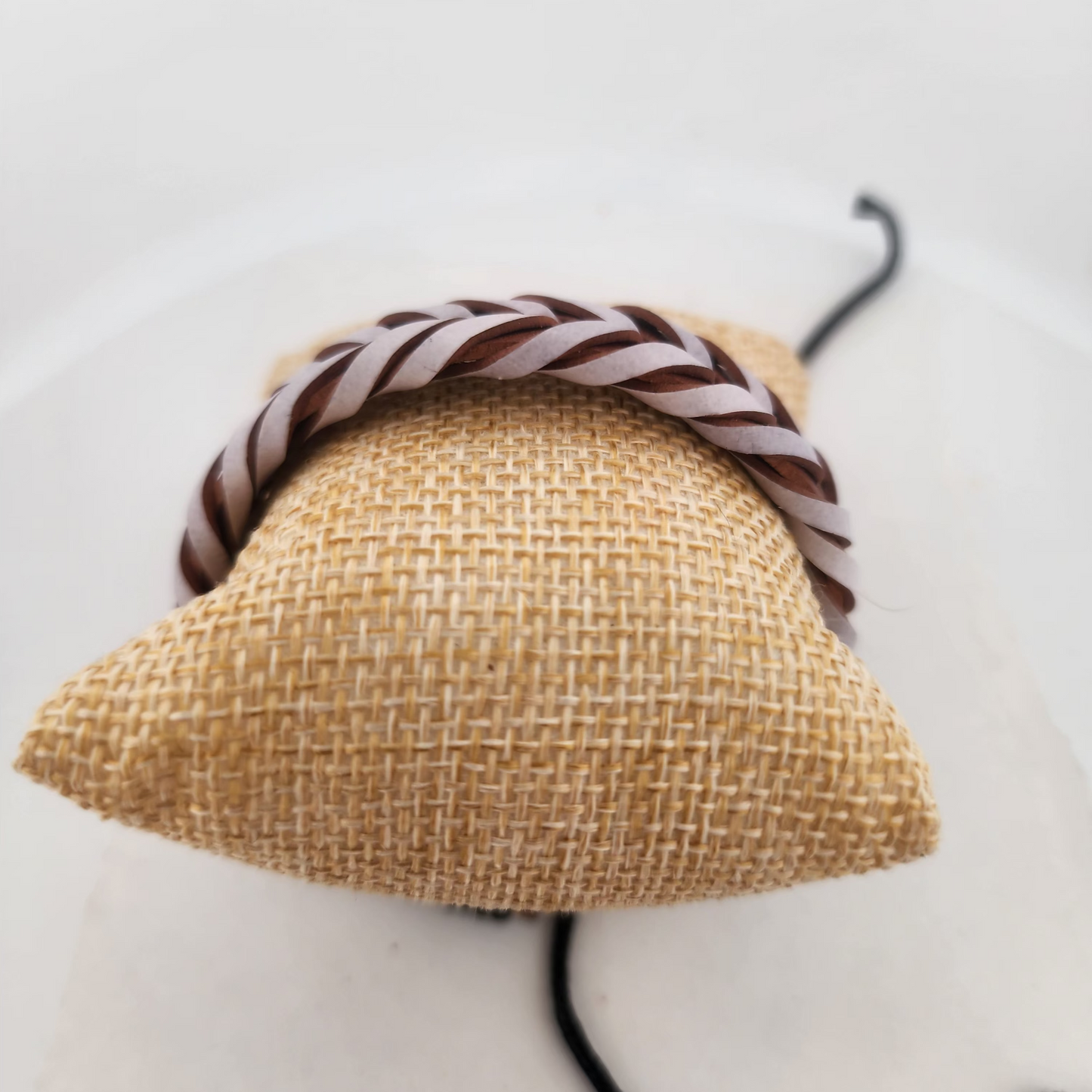 Woven headband with a striped pattern on a white background