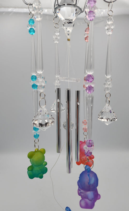 Decorative hanging crystal with colorful beads against a plain background