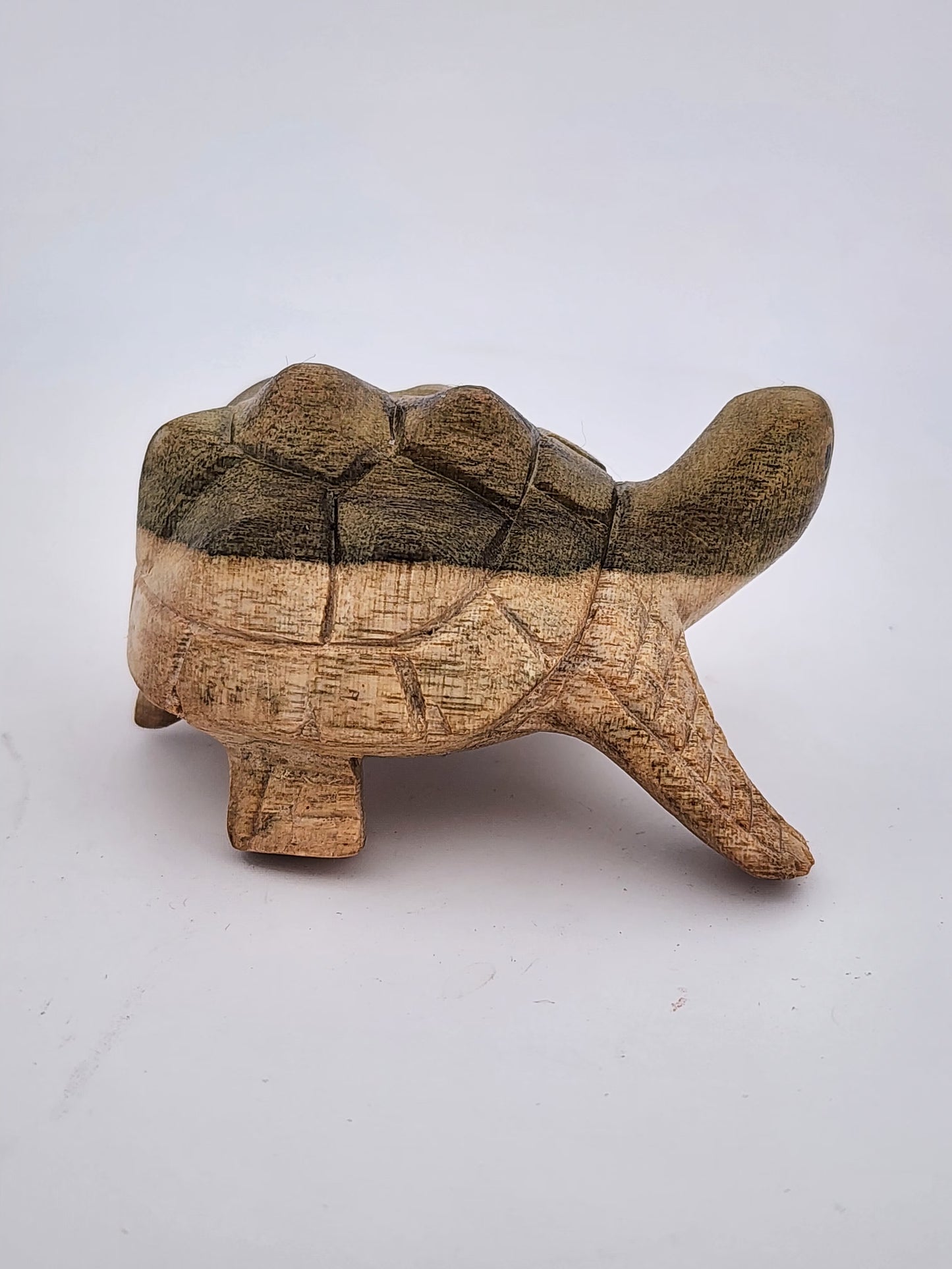 Wooden turtle figurine on a white background