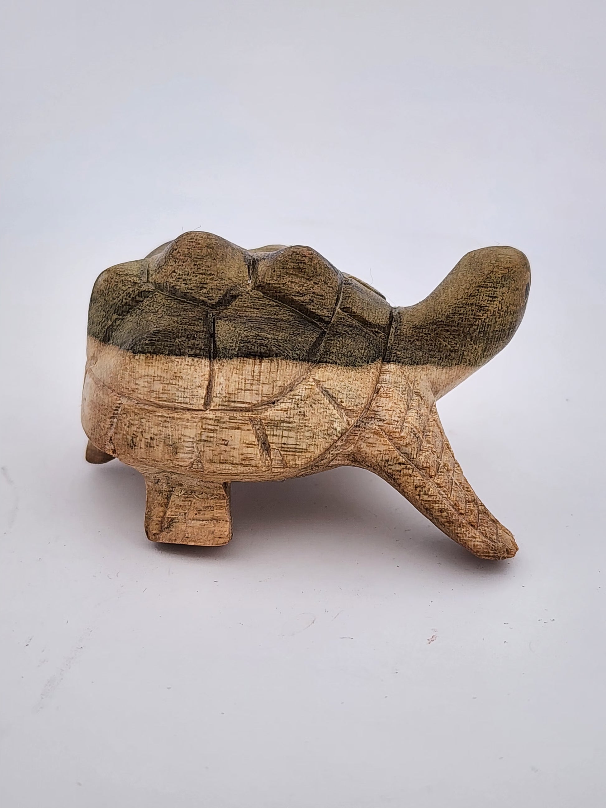 Wooden turtle figurine on a white background