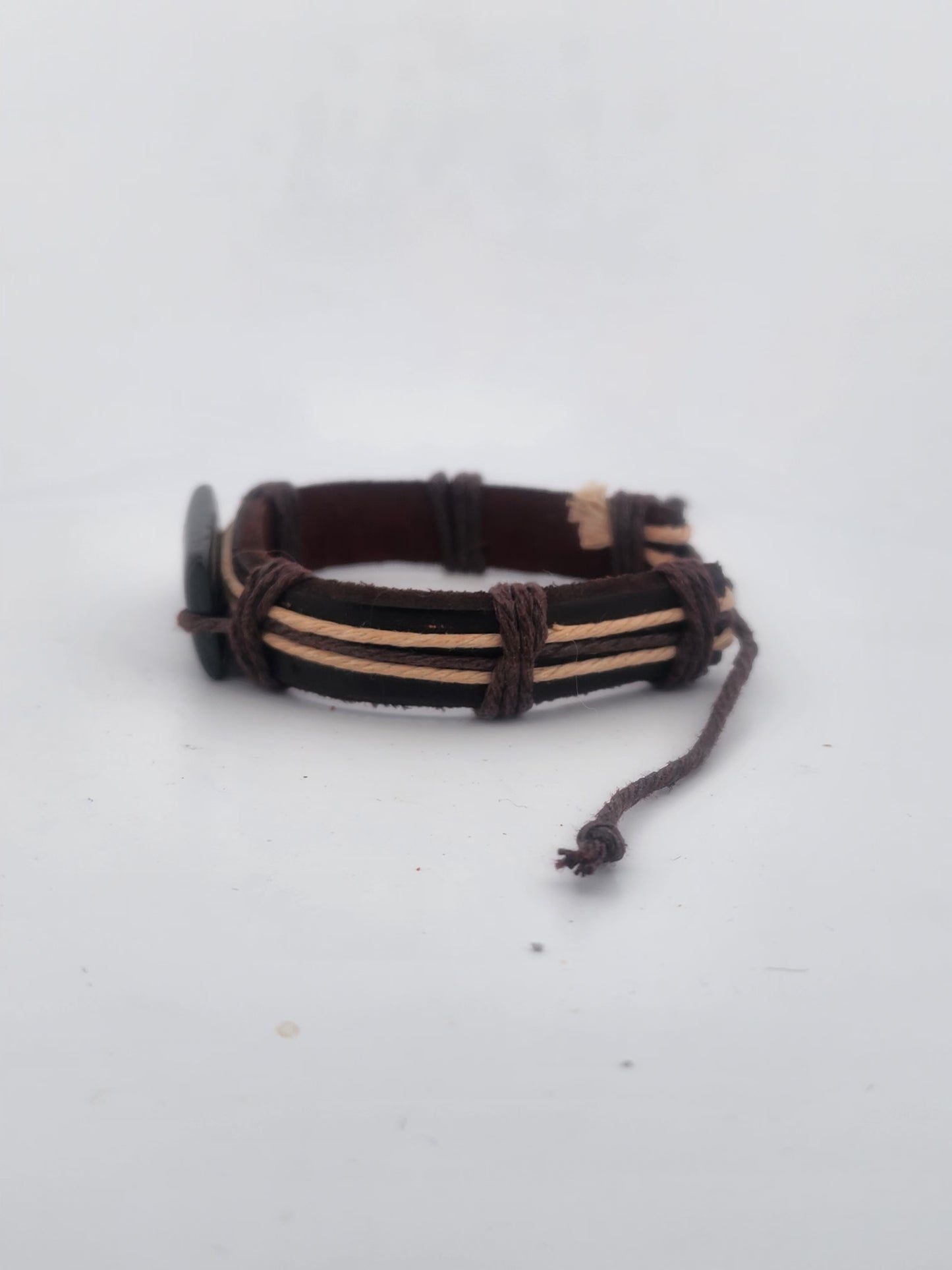 Bracelet with brown and beige cord on a white background