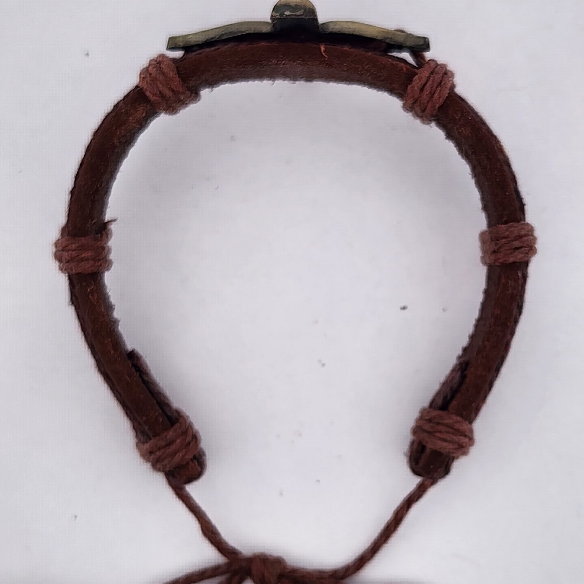 Brown leather bracelet with a knot on a white background