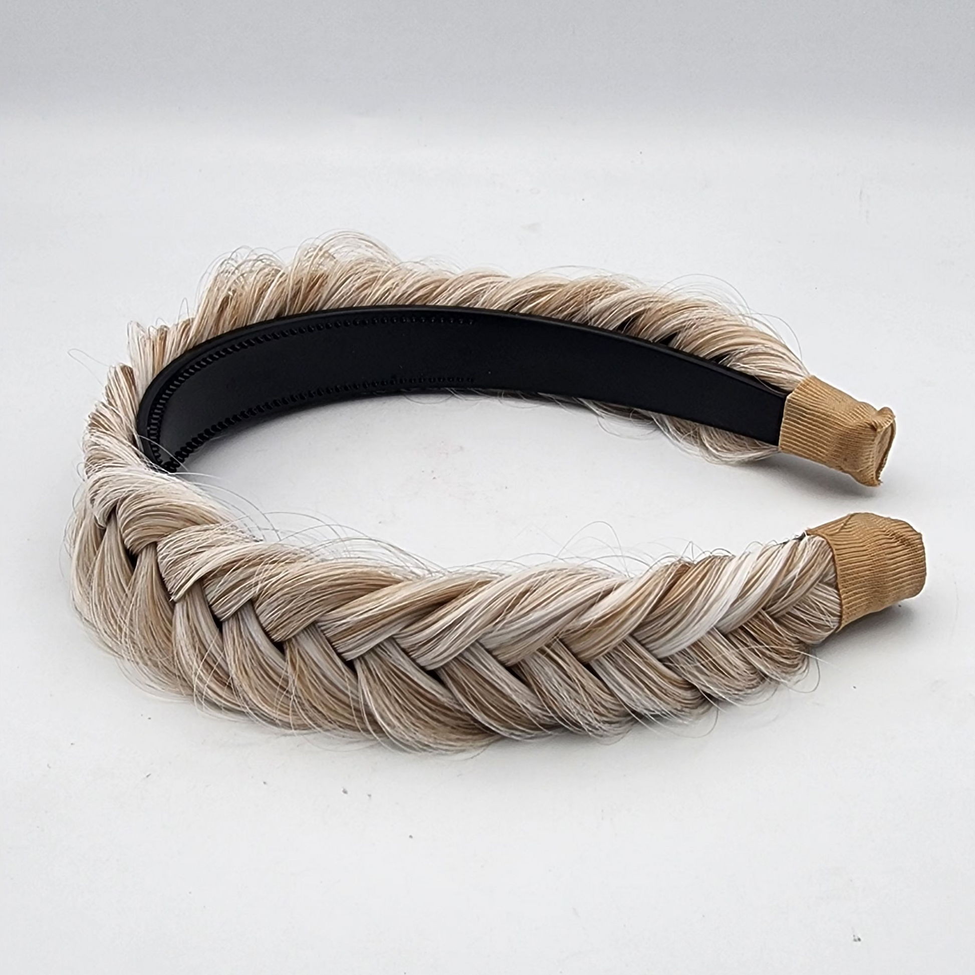 Braided hairband with beige and black band on a white background