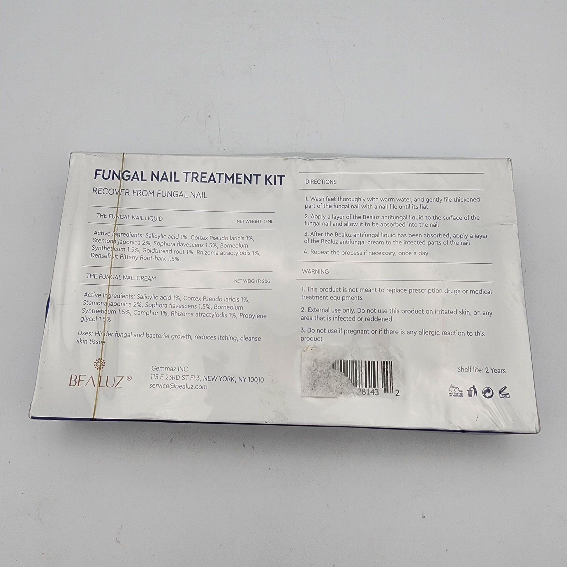 Back of a fungal nail treatment kit packaging on a gray background