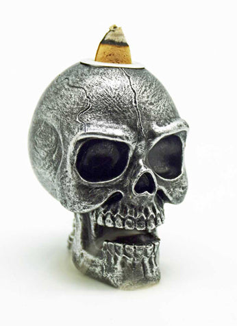 Skull-shaped object with a pointed top on a white background
